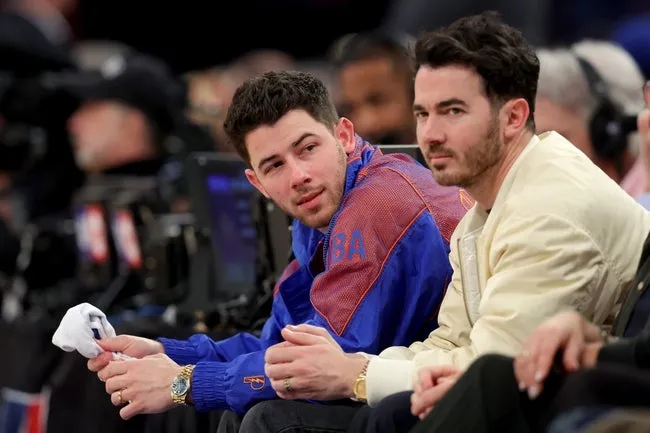 Apr 21, 2025; New York, New York, USA; American singers Nick Jonas (left) and Kevin Jonas sit courtside during the second quarter of game two of the first round of the 2024 NBA Playoffs between the New York Knicks and the Detroit Pistons at Madison Square Garden. © Brad Penner-Imagn Images