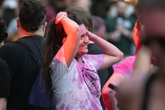 A FEST attendee stands covered in fake blood during FEST 21 after GWARs set on Oct. 27, 2023, in downtown Gainesville, Fla.