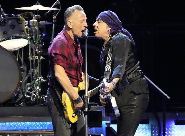 Bruce Springsteen and guitarist Steven Van Zandt share the microphone while performing with the E Street Band during Springsteen's tour relaunch at the Footprint Center in Phoenix on March 19, 2024.